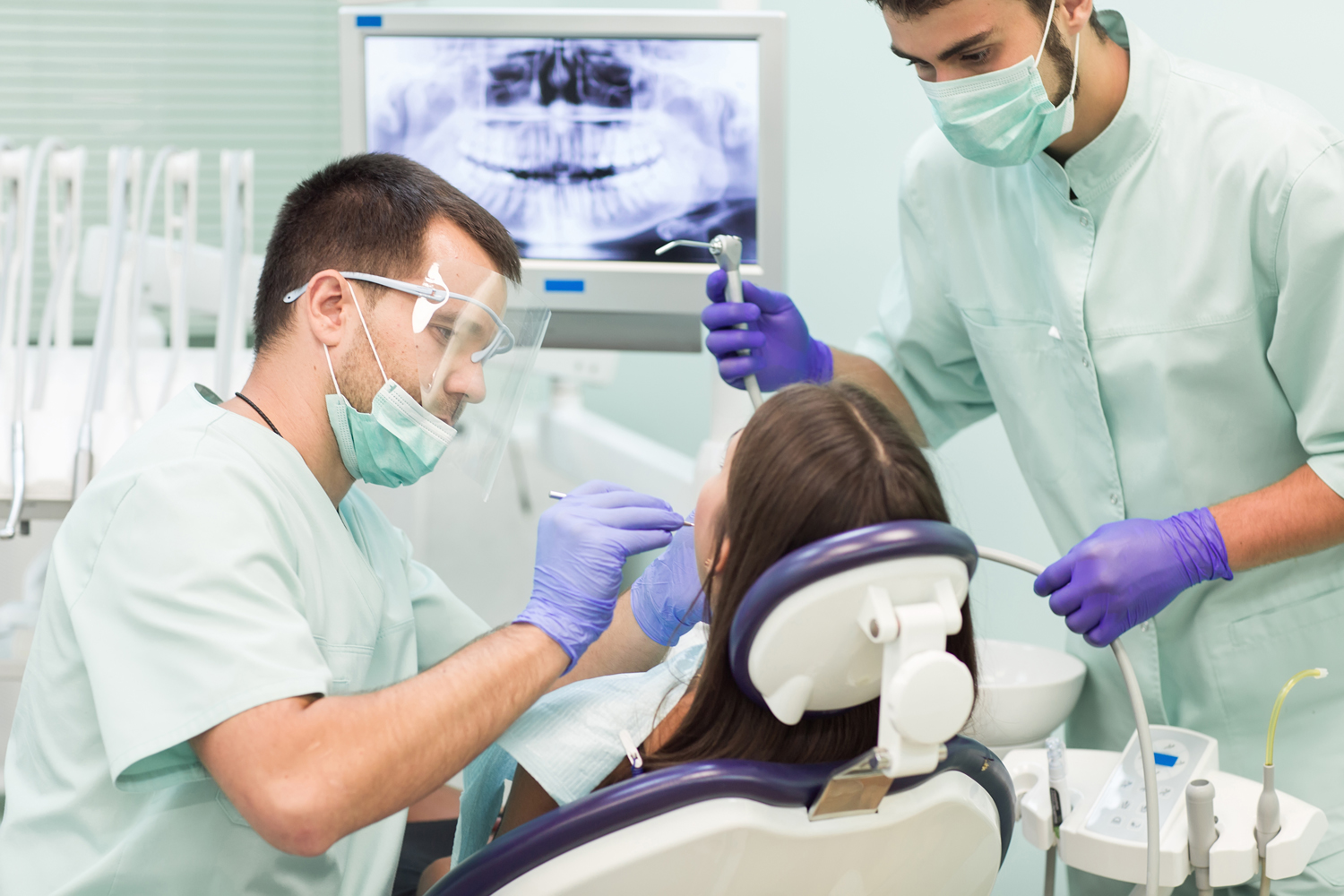 Doctor Dentist with an assistant work in a dental clinic.