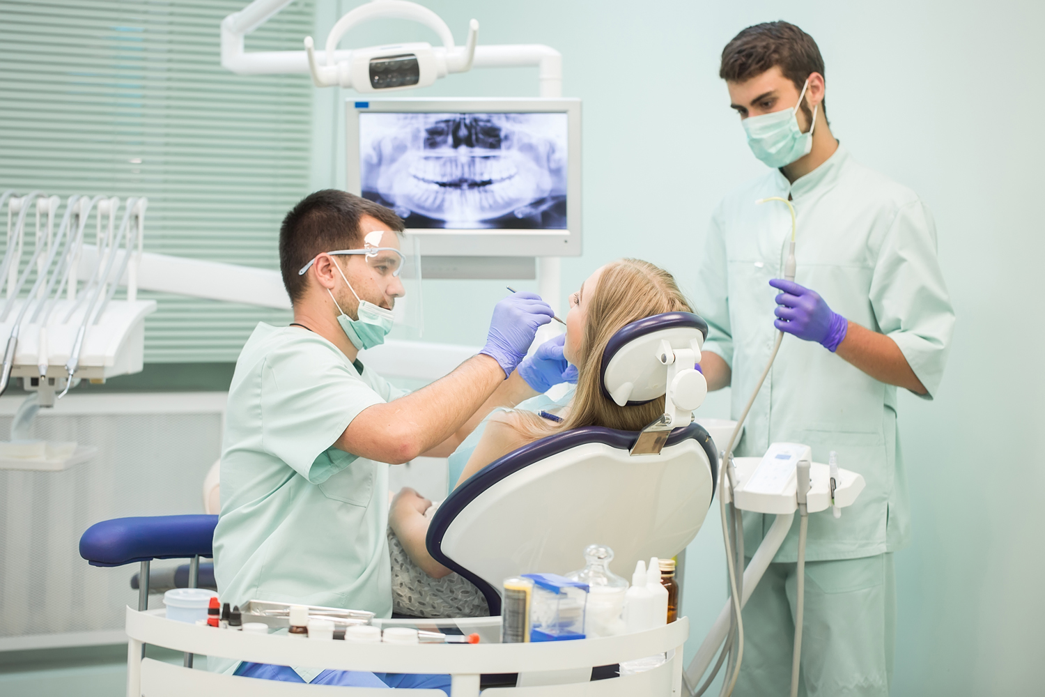 Doctor Dentist with an assistant work in a dental clinic.