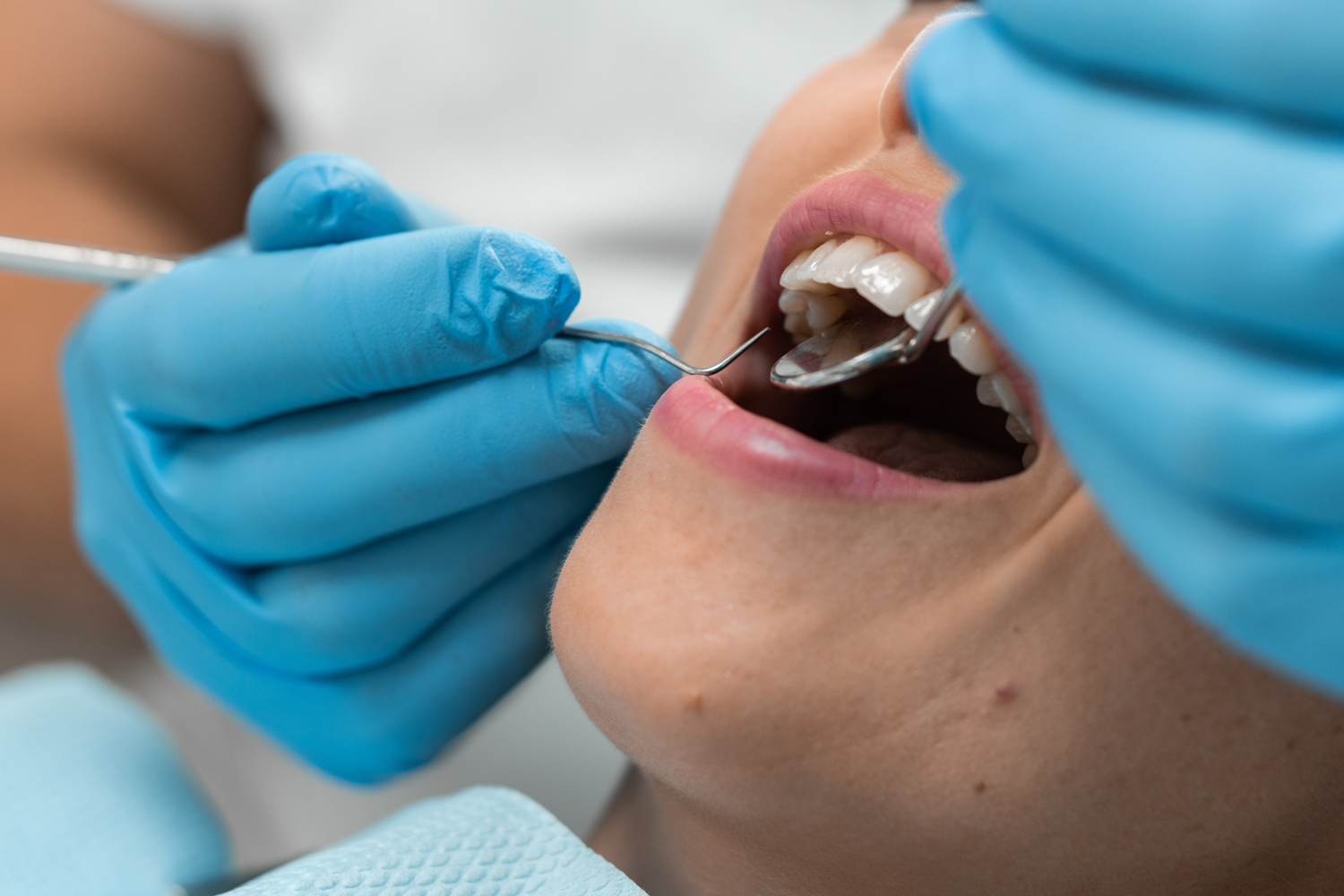 The dentist works in a cozy dental office, providing effective dental care, and the patient in the chair expresses her satisfaction with high-quality medical care and maintaining health.
